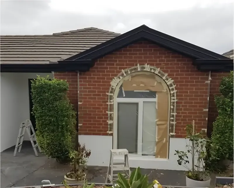 Before: brick front with an arched window, masked up