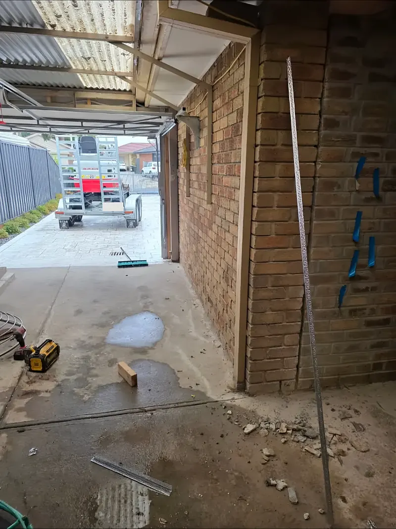 Before: brick carport wall with corner beads going on
