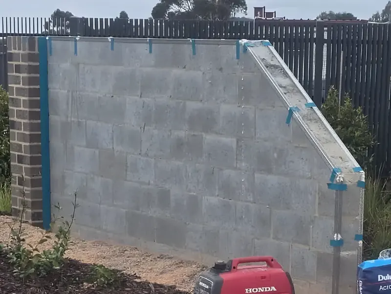Before: bare block wall with corner beads fixed, ready for render